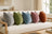 Five upright Castello velvet pillows on an ivory sofa