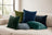 Blue and green Castello velvet pillows on a cream indoor sofa